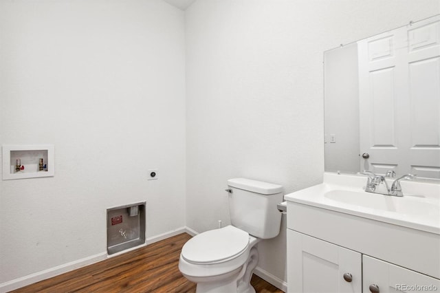 9674 Truckee St, Commerce City, CO 80022 - half bathroom featuring vanity, toilet, baseboards, and wood finished floors