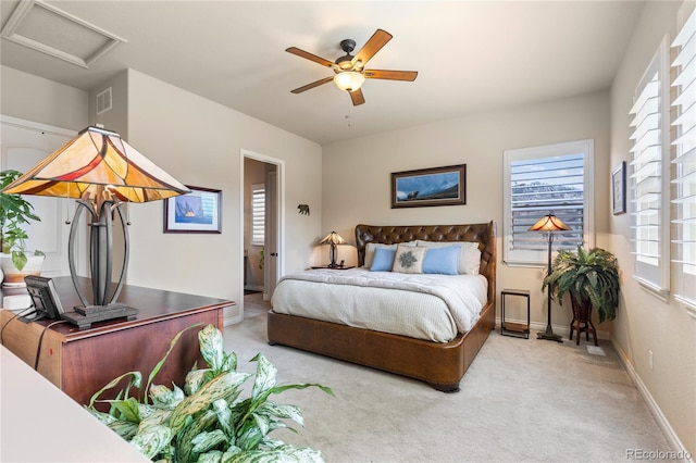 carpeted bedroom featuring baseboards, a ceiling fan, visible vents, and attic access