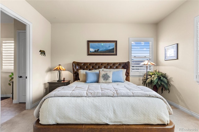 carpeted bedroom featuring baseboards