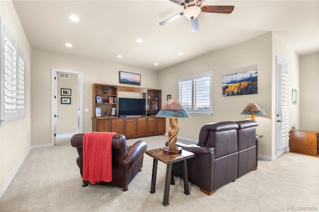living room featuring recessed lighting, baseboards, visible vents, a ceiling fan, and light carpet