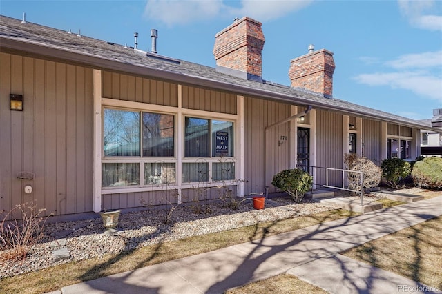 property entrance featuring covered porch and a chimney