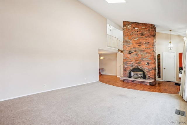 unfurnished living room with carpet floors, high vaulted ceiling, visible vents, and baseboards