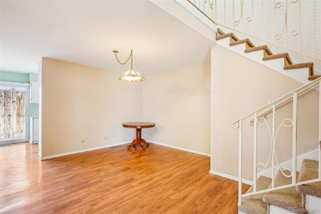 interior space with baseboards and wood finished floors