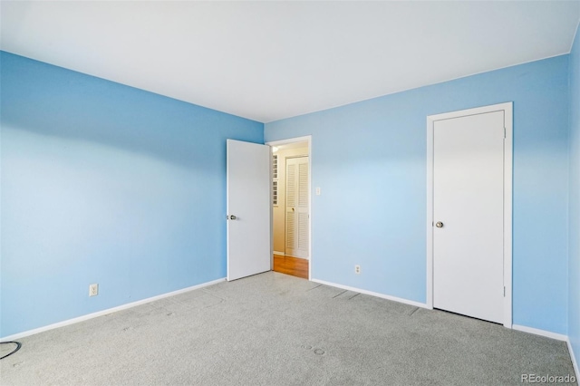 carpeted spare room with baseboards