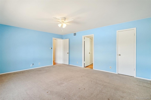 unfurnished bedroom with carpet, visible vents, baseboards, and ceiling fan