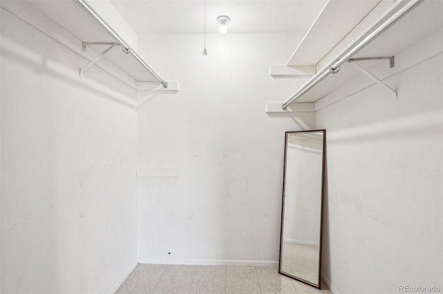 spacious closet featuring light floors