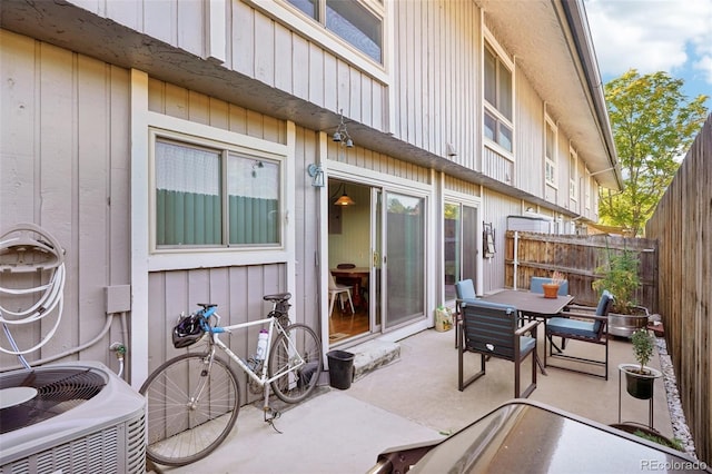 view of patio / terrace with fence, central AC unit, and outdoor dining space