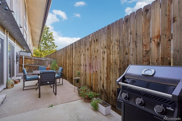 view of patio / terrace featuring a fenced backyard, grilling area, and outdoor dining space