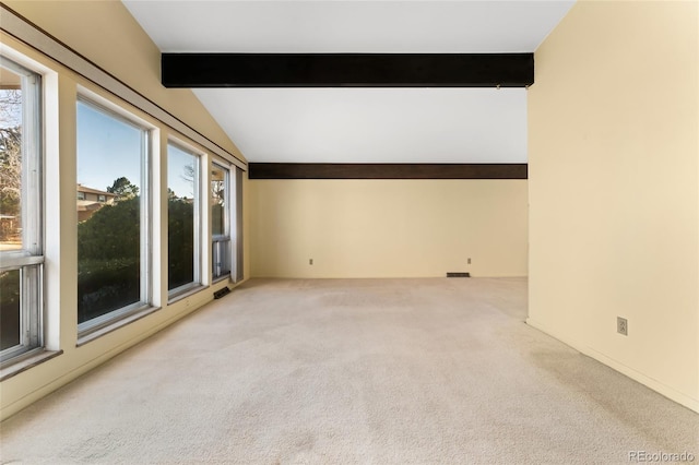 unfurnished room featuring lofted ceiling with beams and carpet floors