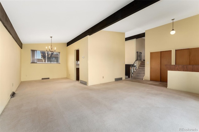 unfurnished living room with a notable chandelier, stairway, lofted ceiling with beams, and carpet floors