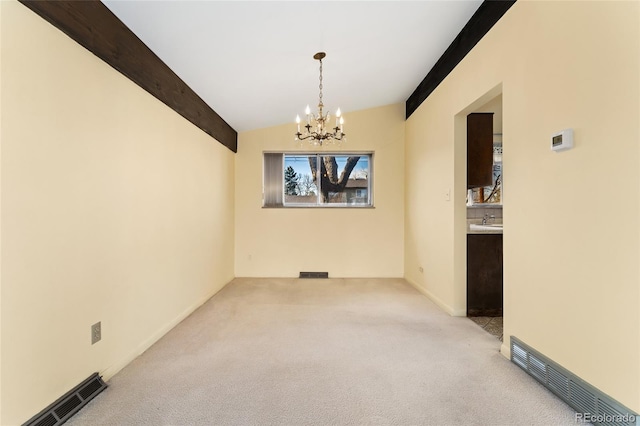 unfurnished dining area with lofted ceiling with beams, light colored carpet, visible vents, and a chandelier