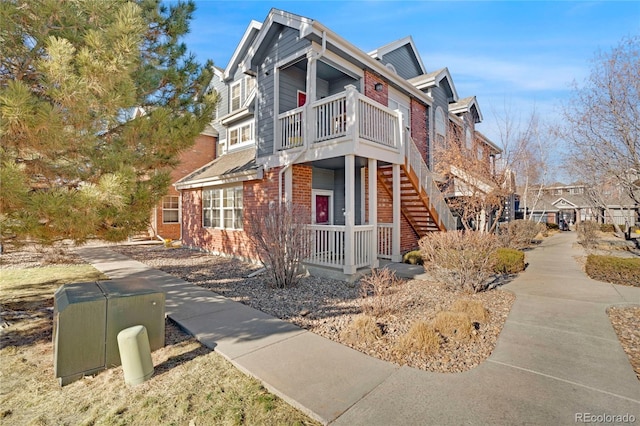 view of side of property featuring brick siding and stairs