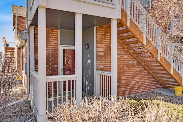 view of exterior entry featuring brick siding