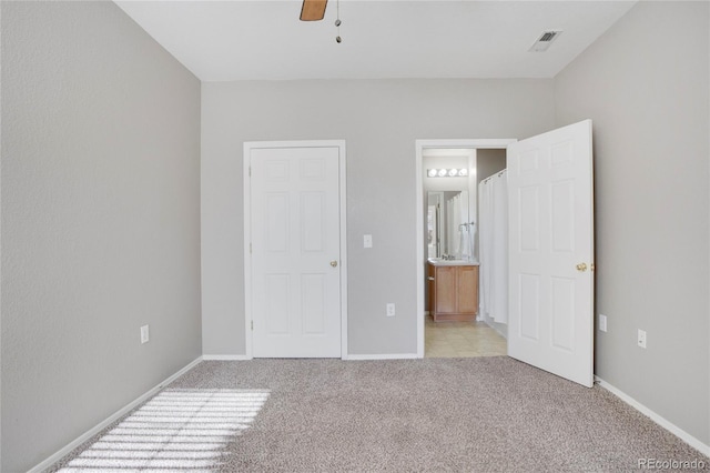 unfurnished bedroom with baseboards, connected bathroom, visible vents, and light colored carpet