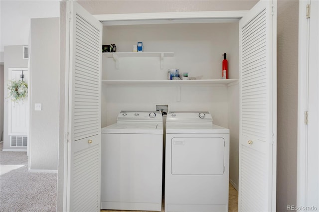 laundry area featuring laundry area, baseboards, visible vents, light colored carpet, and washing machine and clothes dryer