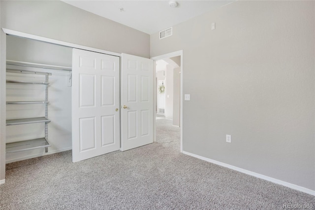 unfurnished bedroom featuring visible vents, a closet, baseboards, and carpet flooring