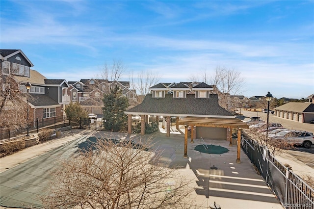 view of front of house featuring fence and a residential view