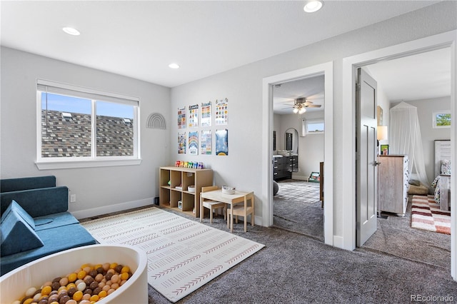 living room with carpet flooring, recessed lighting, a ceiling fan, and baseboards