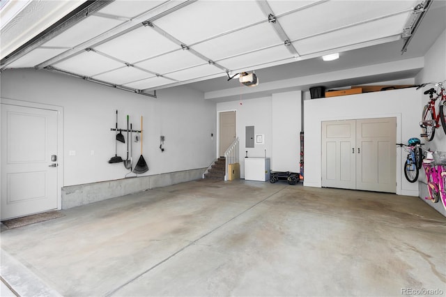 garage featuring electric panel and a garage door opener