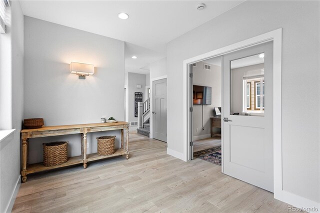 4589 Quandary Peak St, Brighton, CO 80601 - hall featuring light wood-style floors, stairway, recessed lighting, and baseboards