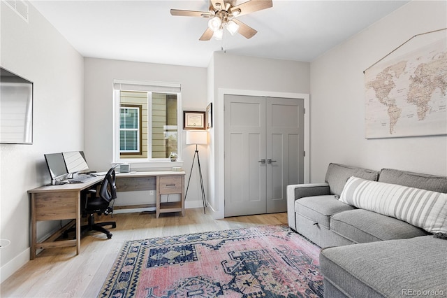 4589 Quandary Peak St, Brighton, CO 80601 - home office featuring ceiling fan, light wood-type flooring, and baseboards
