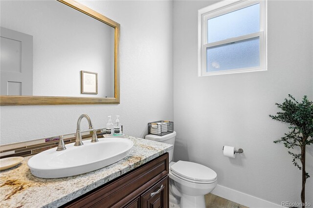4589 Quandary Peak St, Brighton, CO 80601 - bathroom featuring vanity, toilet, and baseboards