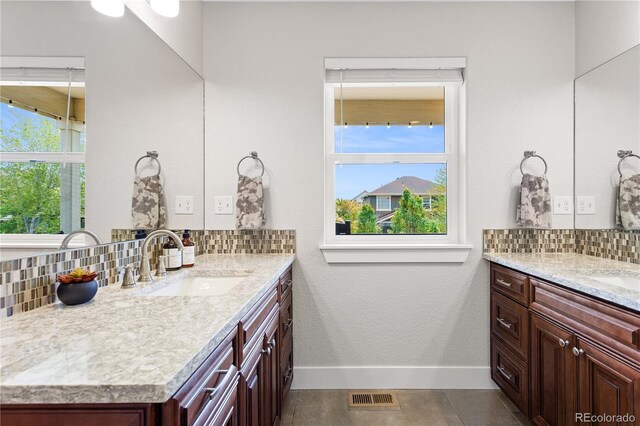 4589 Quandary Peak St, Brighton, CO 80601 - full bath featuring tasteful backsplash, two vanities, and baseboards
