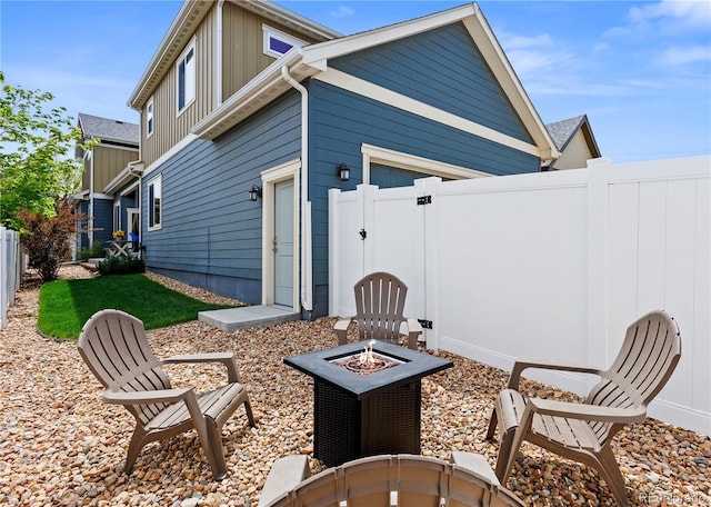 4589 Quandary Peak St, Brighton, CO 80601 - back of house with an outdoor fire pit, a gate, and board and batten siding