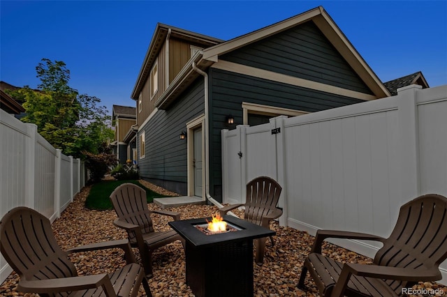 4589 Quandary Peak St, Brighton, CO 80601 - rear view of house featuring a fire pit, a fenced backyard, and a gate