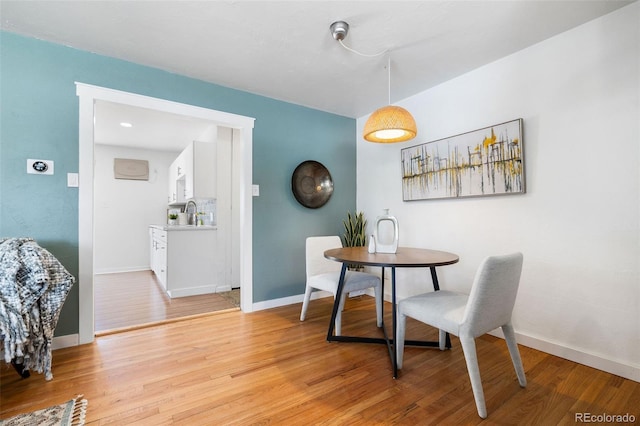 dining area featuring sink and light wood-type flooring