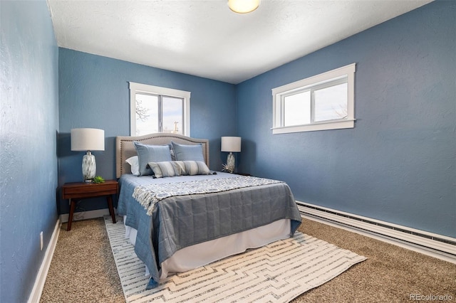 carpeted bedroom featuring a baseboard heating unit