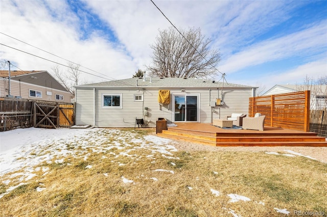 snow covered house with a lawn and a deck