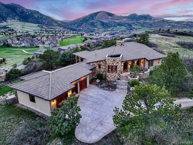 aerial view at dusk featuring a mountain view