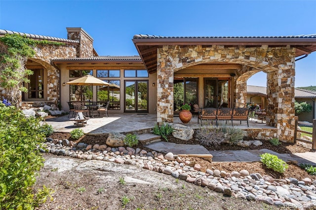 back of property with french doors and a patio