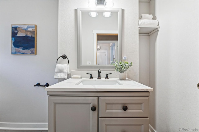 bathroom with vanity and baseboards