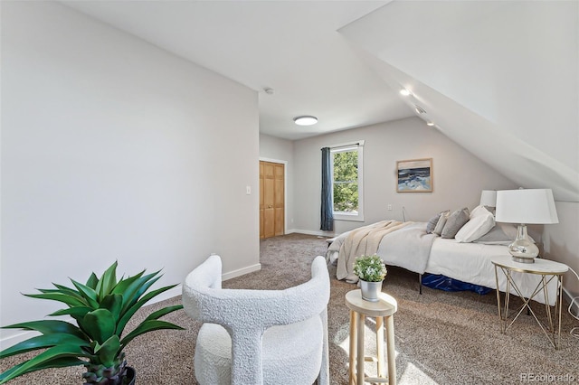 bedroom featuring lofted ceiling, carpet flooring, and baseboards