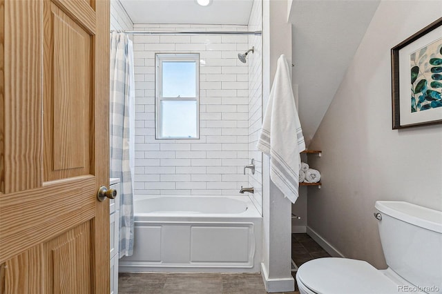 bathroom featuring shower / bath combination with curtain and toilet