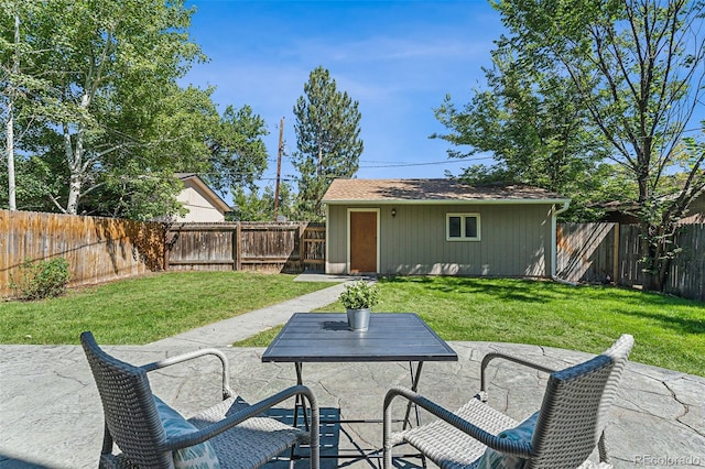 view of patio with a fenced backyard and an outdoor structure