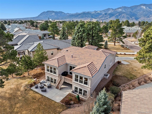 birds eye view of property with a mountain view and a residential view