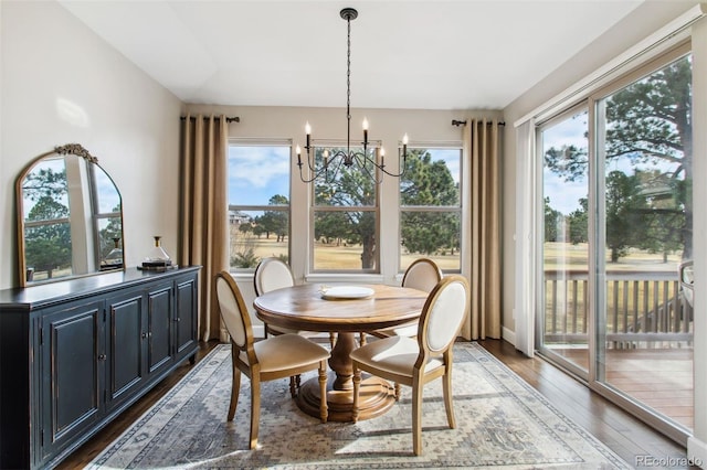 dining area with an inviting chandelier, wood finished floors, and a healthy amount of sunlight