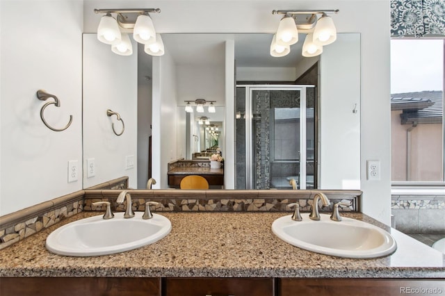 full bath featuring double vanity, a stall shower, and a sink