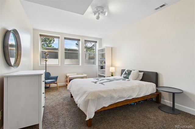 carpeted bedroom with visible vents and baseboards