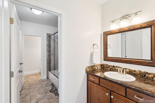 full bathroom with vanity and shower / bath combination with glass door