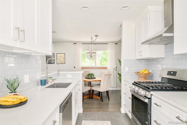 5885 S Huron St, Littleton, CO 80120 - kitchen featuring appliances with stainless steel finishes, wall chimney exhaust hood, white cabinetry, backsplash, and recessed lighting