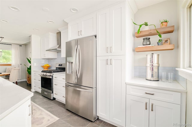 5885 S Huron St, Littleton, CO 80120 - kitchen featuring stainless steel appliances, wall chimney exhaust hood, white cabinets, tasteful backsplash, and open shelves