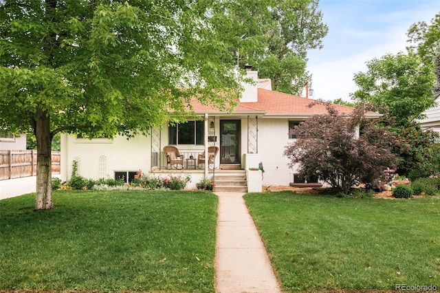 5885 S Huron St, Littleton, CO 80120 - view of property hidden behind natural elements featuring covered porch, a chimney, and roof with shingles