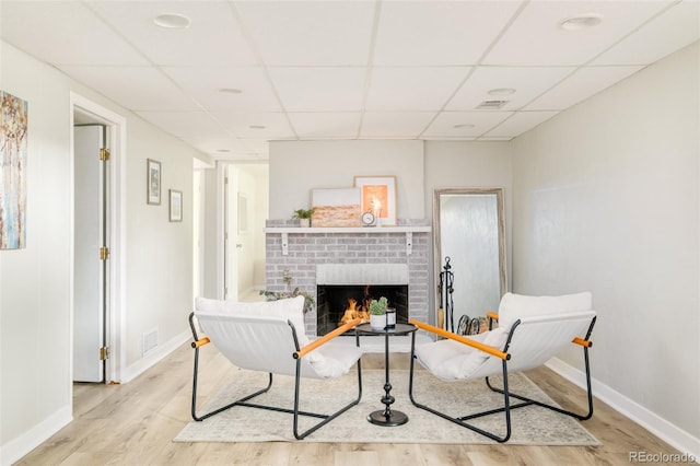 5885 S Huron St, Littleton, CO 80120 - living room with light wood finished floors, a fireplace, and a drop ceiling