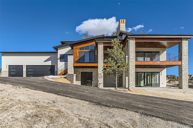 modern home with a garage and a balcony