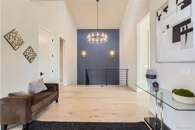 foyer entrance featuring a notable chandelier and light hardwood / wood-style flooring