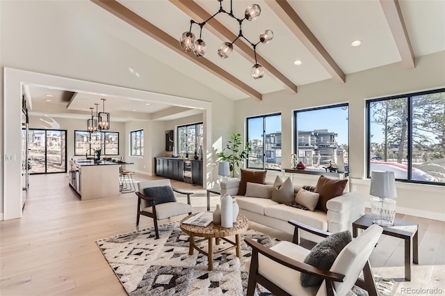 living room with sink, high vaulted ceiling, beamed ceiling, light hardwood / wood-style floors, and a chandelier